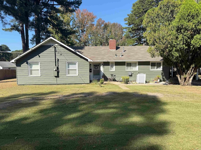 rear view of property with a lawn