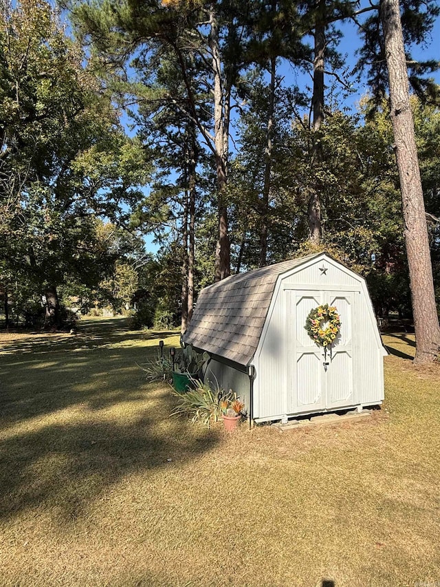 view of outdoor structure featuring a lawn