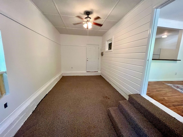 basement featuring wood-type flooring and ceiling fan