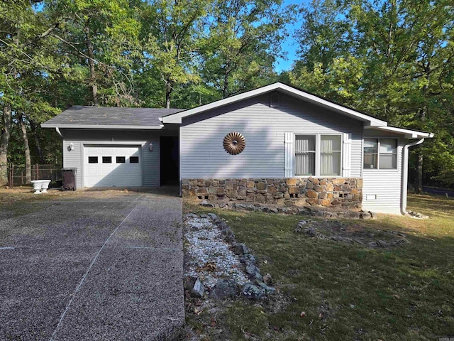 ranch-style home with a front lawn and a garage