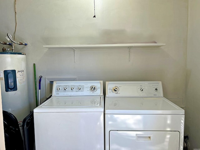 laundry room featuring electric water heater and washing machine and dryer