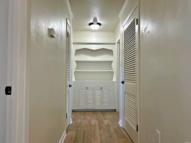 hall with crown molding and hardwood / wood-style flooring