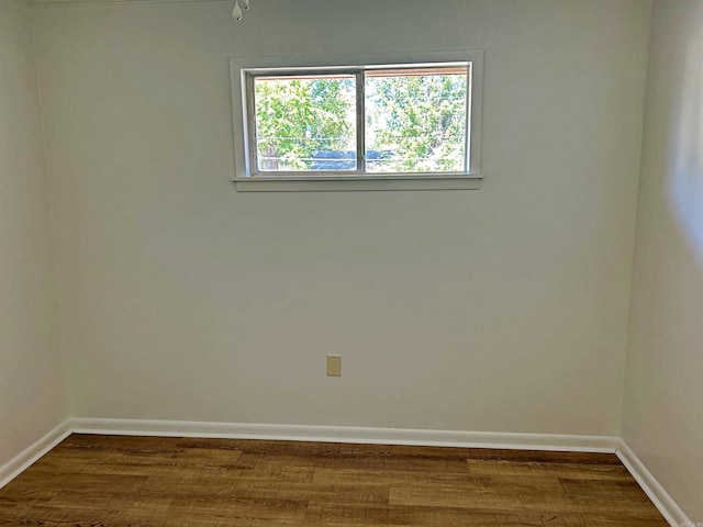 spare room with wood-type flooring