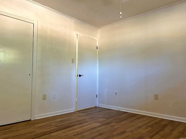 unfurnished room featuring ornamental molding and dark hardwood / wood-style floors