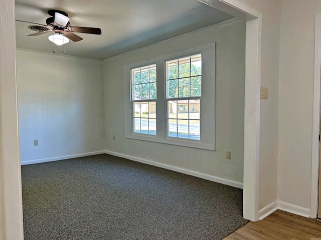 empty room with ceiling fan, ornamental molding, and wood-type flooring