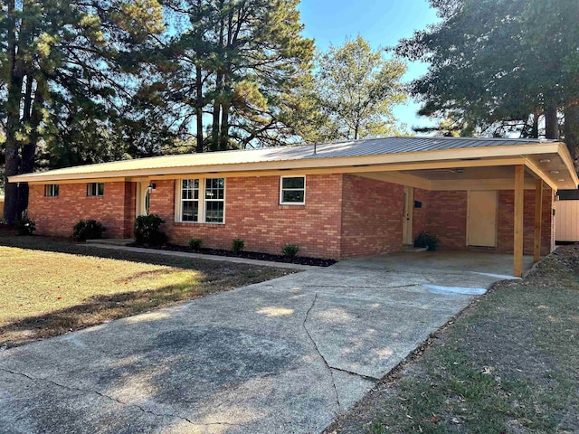 ranch-style house with a front yard and a carport