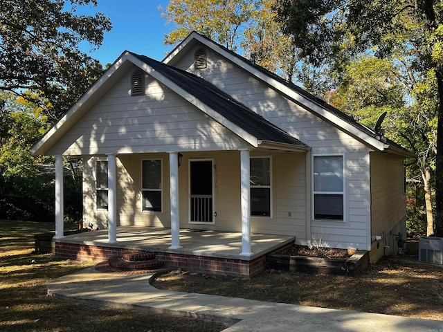 bungalow with covered porch and central AC unit