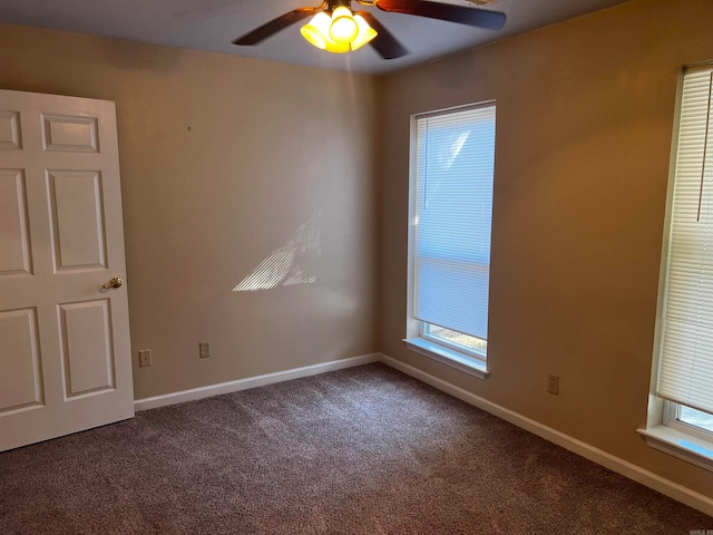 carpeted empty room with ceiling fan and plenty of natural light