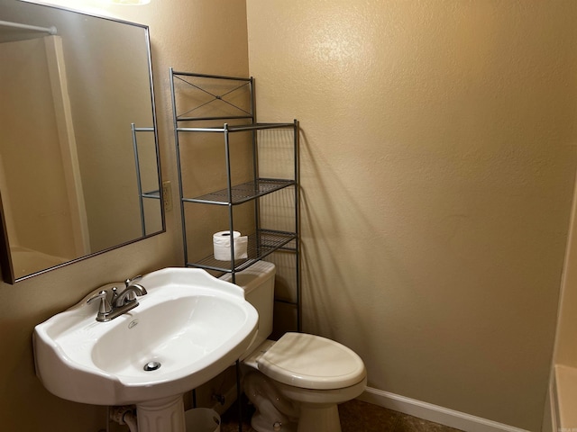 bathroom featuring toilet and sink