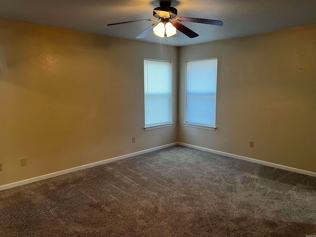 carpeted spare room with ceiling fan