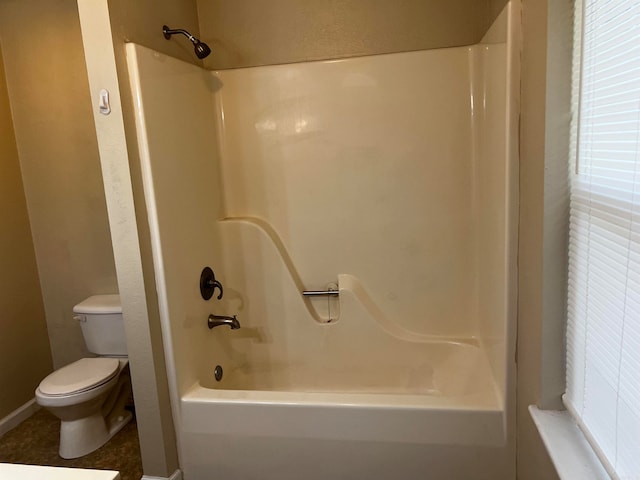 bathroom featuring toilet and bathtub / shower combination