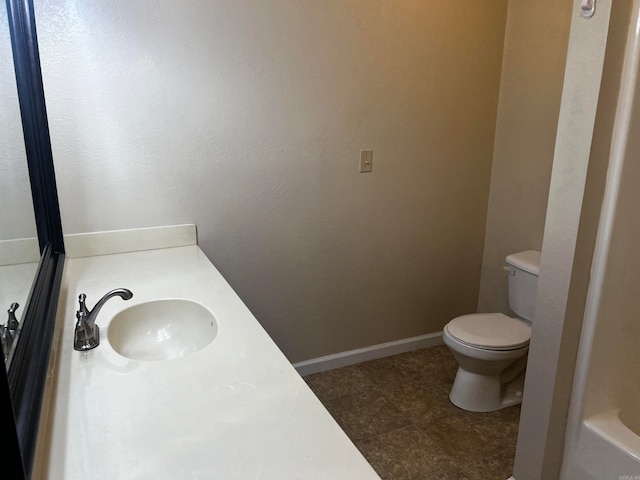 bathroom featuring a bath, toilet, and vanity