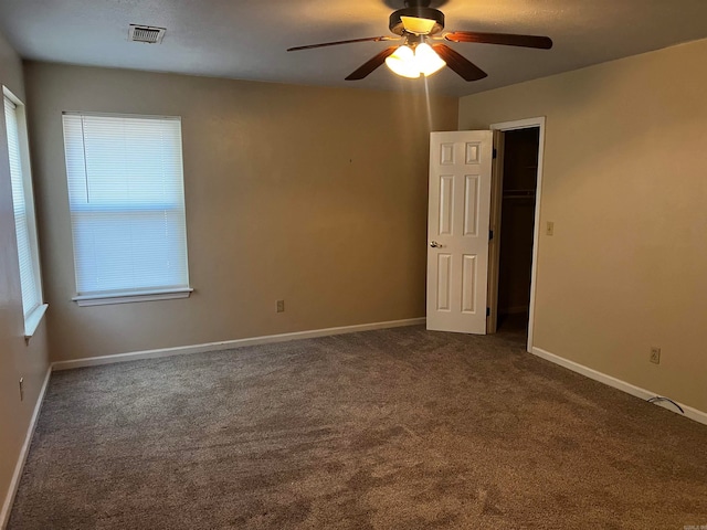 carpeted spare room with ceiling fan