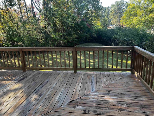 wooden deck featuring a yard