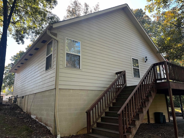 view of property exterior featuring a wooden deck