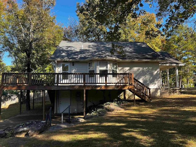 rear view of property featuring a wooden deck and a yard