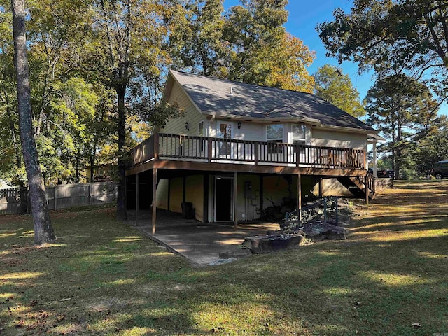 back of property with a wooden deck, a patio area, and a yard