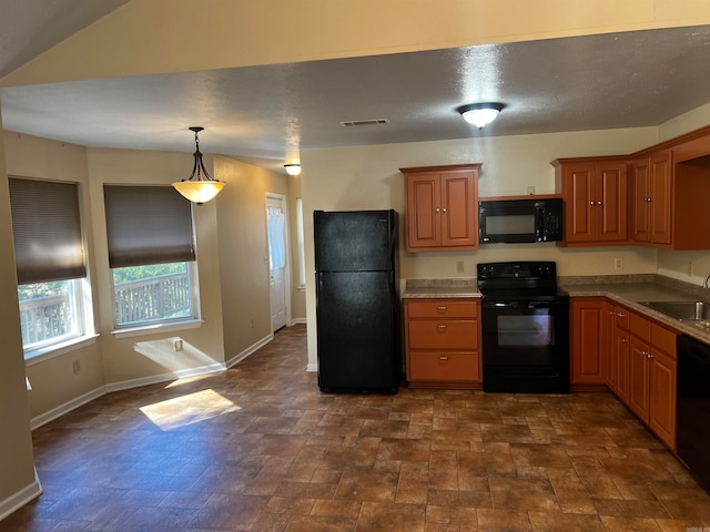 kitchen with black appliances, sink, and hanging light fixtures