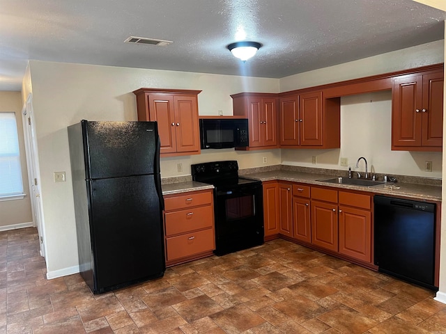 kitchen with a textured ceiling, black appliances, and sink