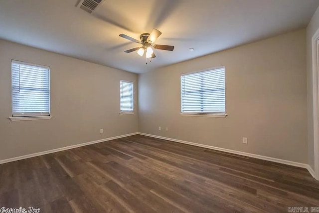 spare room featuring dark wood-type flooring and ceiling fan