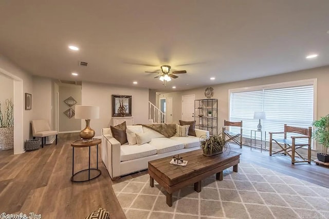 living room with ceiling fan and light hardwood / wood-style flooring