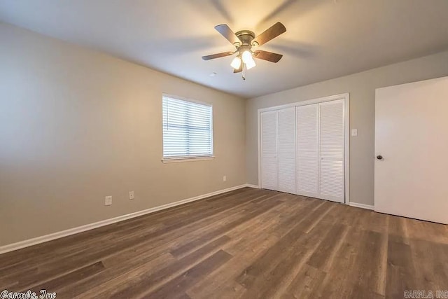 unfurnished bedroom featuring dark hardwood / wood-style flooring, a closet, and ceiling fan