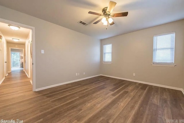 unfurnished room with dark hardwood / wood-style floors and ceiling fan