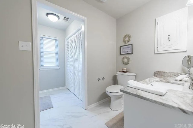 bathroom featuring vanity and toilet