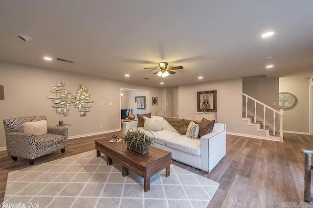 living room featuring hardwood / wood-style floors and ceiling fan