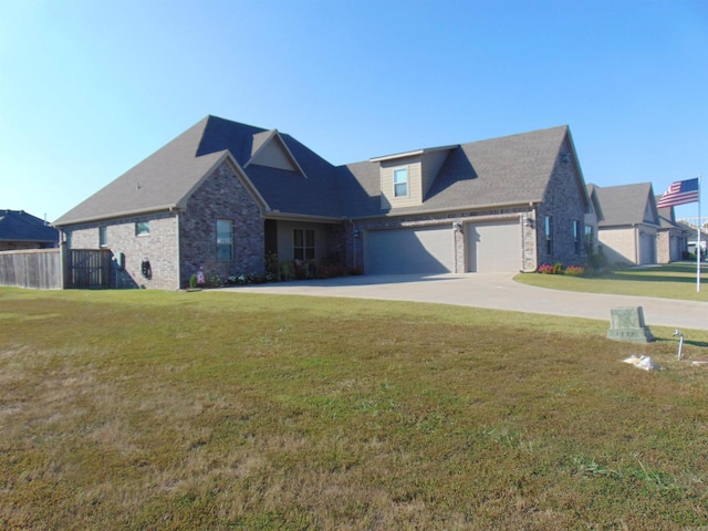 view of front of house featuring a front lawn and a garage