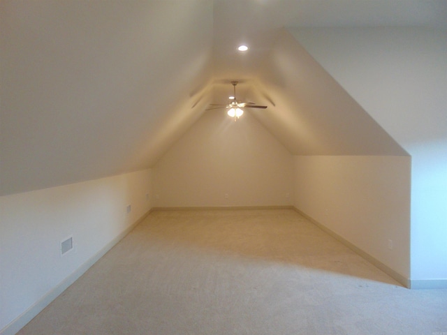 bonus room with light carpet, vaulted ceiling, and ceiling fan