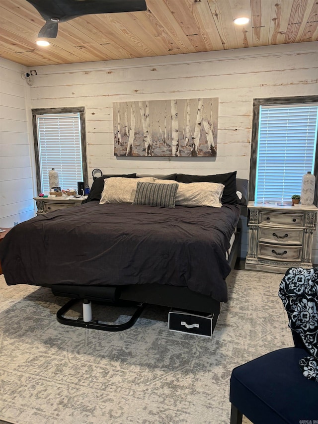 bedroom featuring wooden walls and wood ceiling