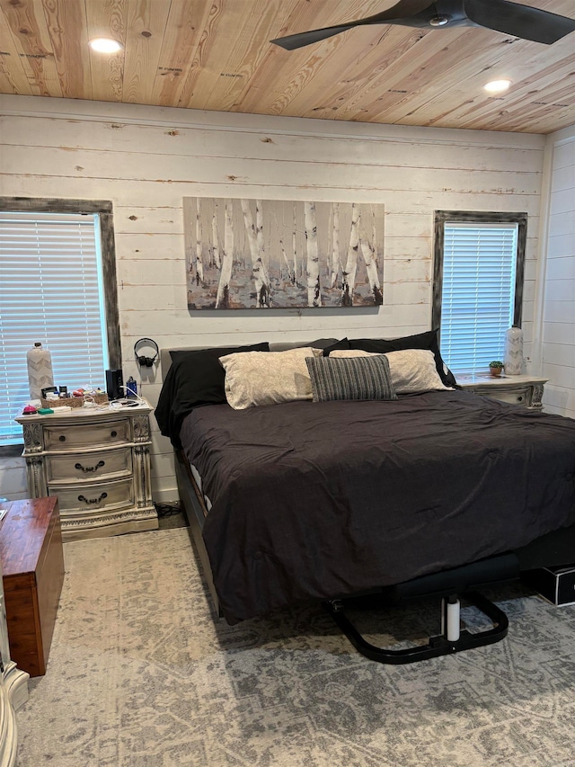 bedroom with wood ceiling, wooden walls, and ceiling fan