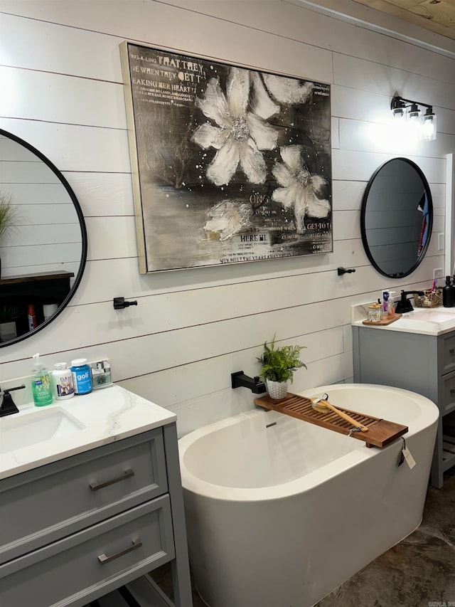 bathroom featuring vanity, wooden walls, and a bath