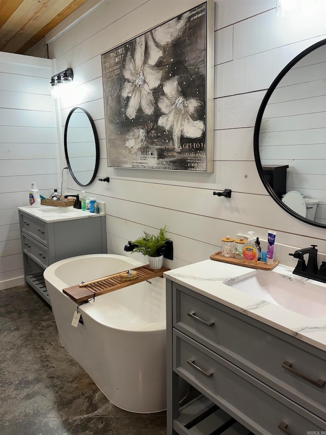 bathroom with vanity, wood walls, and a bathing tub