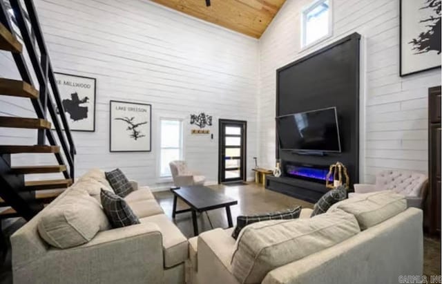 living room featuring stairs, high vaulted ceiling, and wooden ceiling