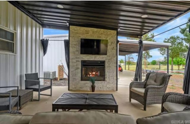view of patio / terrace featuring an outdoor living space with a fireplace