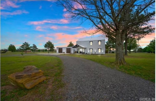 view of front of house with driveway, a garage, and a front lawn