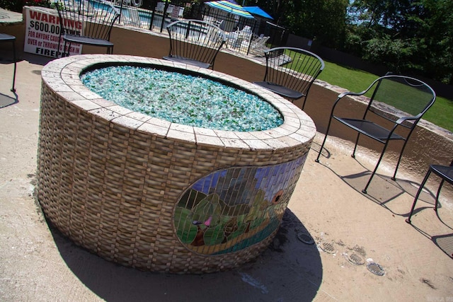 view of pool with a hot tub and a patio