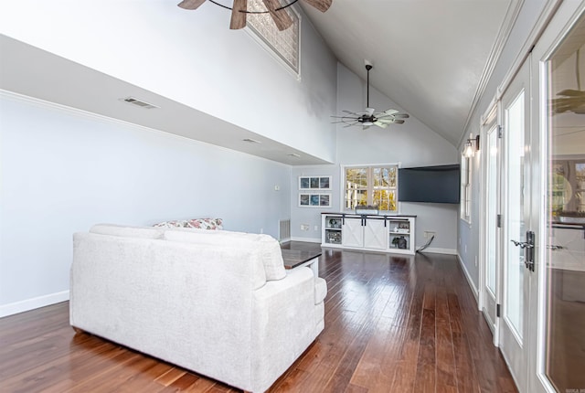 living room featuring dark wood-type flooring, ceiling fan, high vaulted ceiling, and ornamental molding