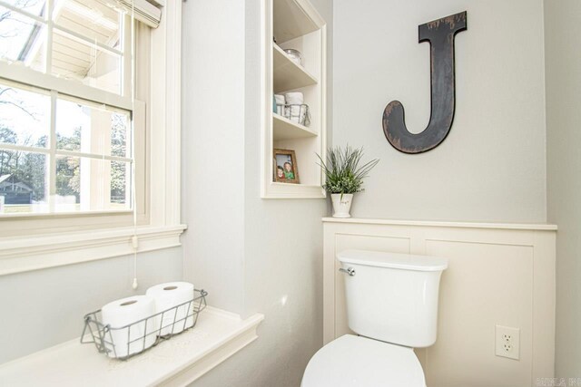 bathroom with a wealth of natural light and toilet