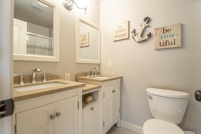 bathroom featuring vanity, toilet, and an enclosed shower