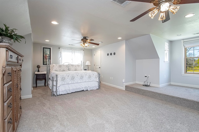 carpeted bedroom featuring multiple windows and ceiling fan