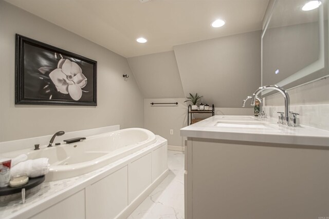 full bathroom featuring recessed lighting, lofted ceiling, marble finish floor, a garden tub, and vanity