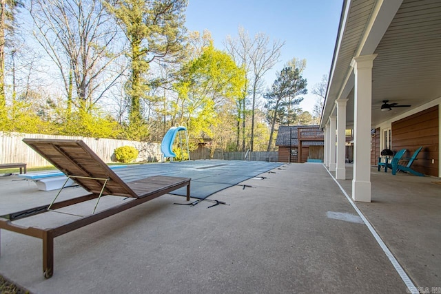 view of patio / terrace with a shed and ceiling fan