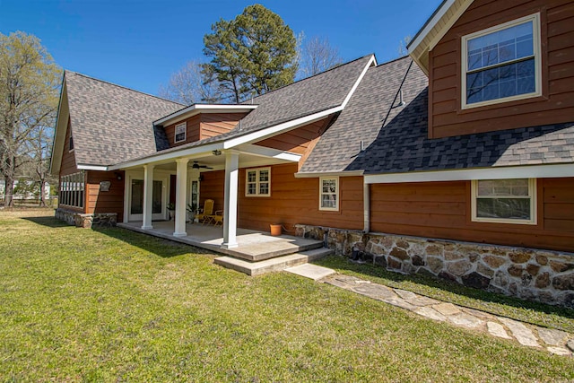 back of property featuring a yard, a patio area, and ceiling fan