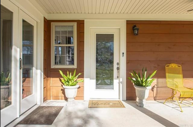 view of exterior entry featuring a porch