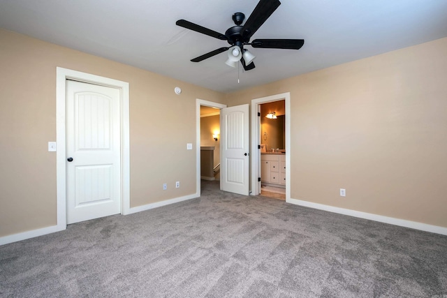 unfurnished bedroom with a closet, ceiling fan, carpet floors, and ensuite bath