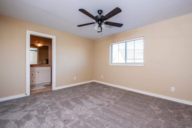 unfurnished bedroom with ensuite bathroom, sink, carpet, and ceiling fan