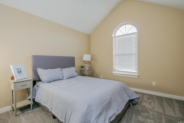 bedroom with carpet floors and vaulted ceiling